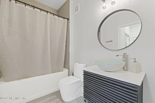 a view of a chair and table in the balcony