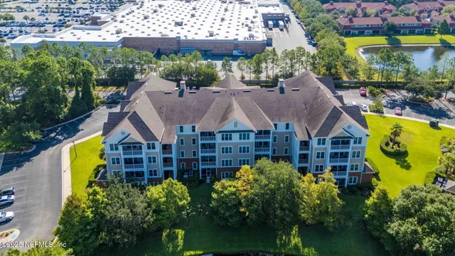 a aerial view of a brick house next to a yard