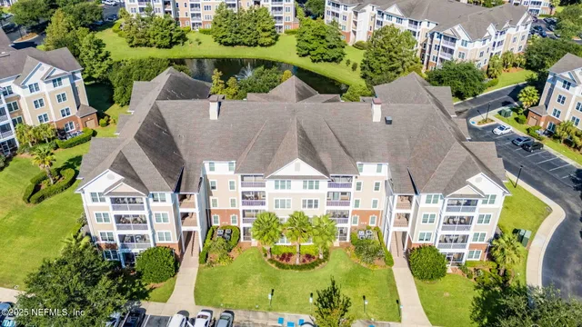 a aerial view of a brick house next to a yard