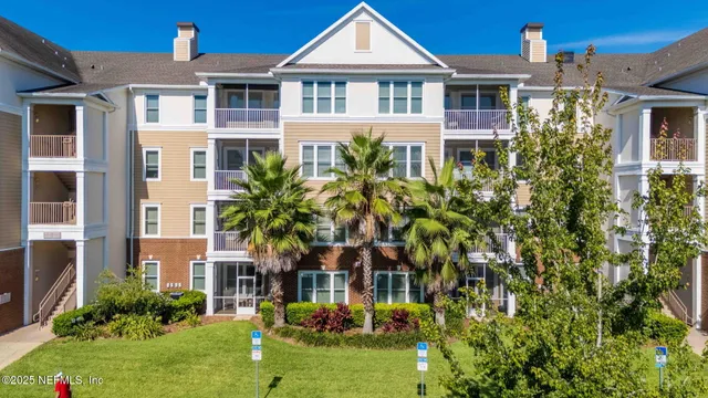 a front view of a residential houses with yard and green space