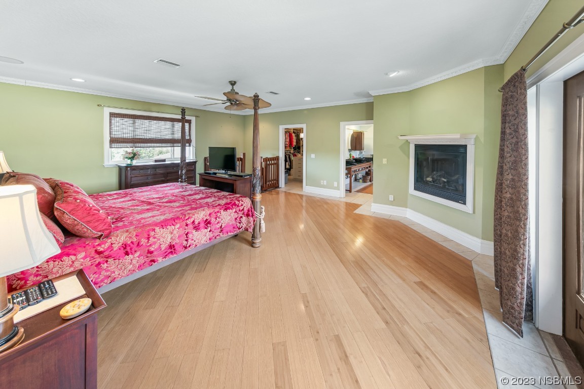 33 Calumet Avenue Ponce Inlet, FL 32127 - Photo 27 of 48 a bedroom with a bed and a flat screen tv