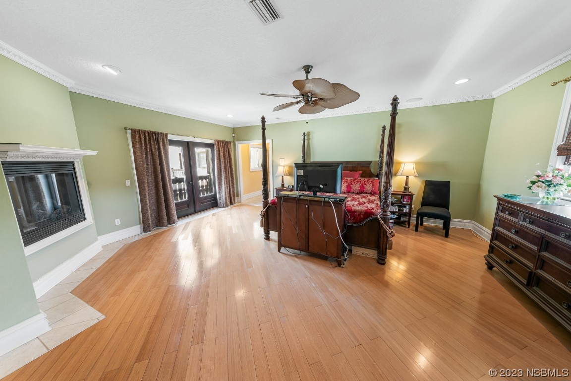 33 Calumet Avenue Ponce Inlet, FL 32127 - Photo 28 of 48 a bed room with furniture and a flat screen tv