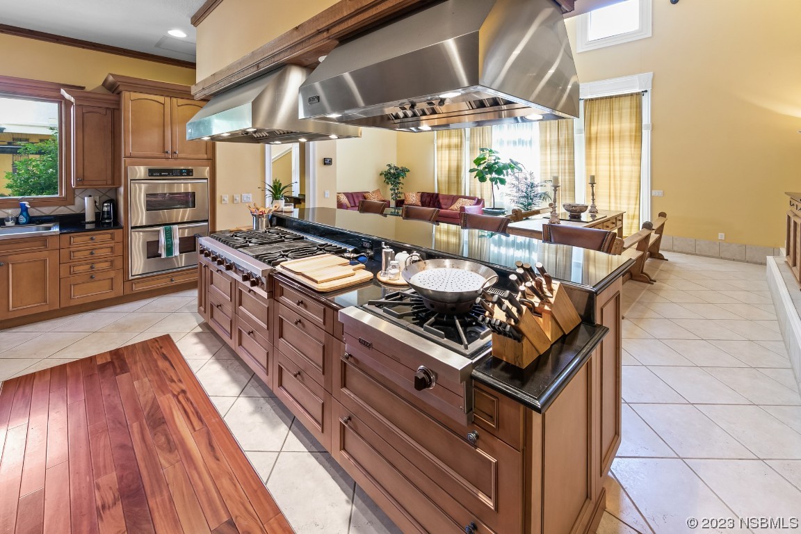 33 Calumet Avenue Ponce Inlet, FL 32127 - Photo 7 of 48 a kitchen with stainless steel appliances a stove a sink dishwasher and cabinets with wooden floor