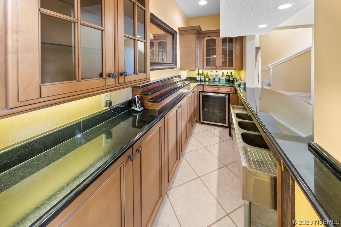 33 Calumet Avenue Ponce Inlet, FL 32127 - Photo 10 of 48 a kitchen with a sink a counter top space and stainless steel appliances