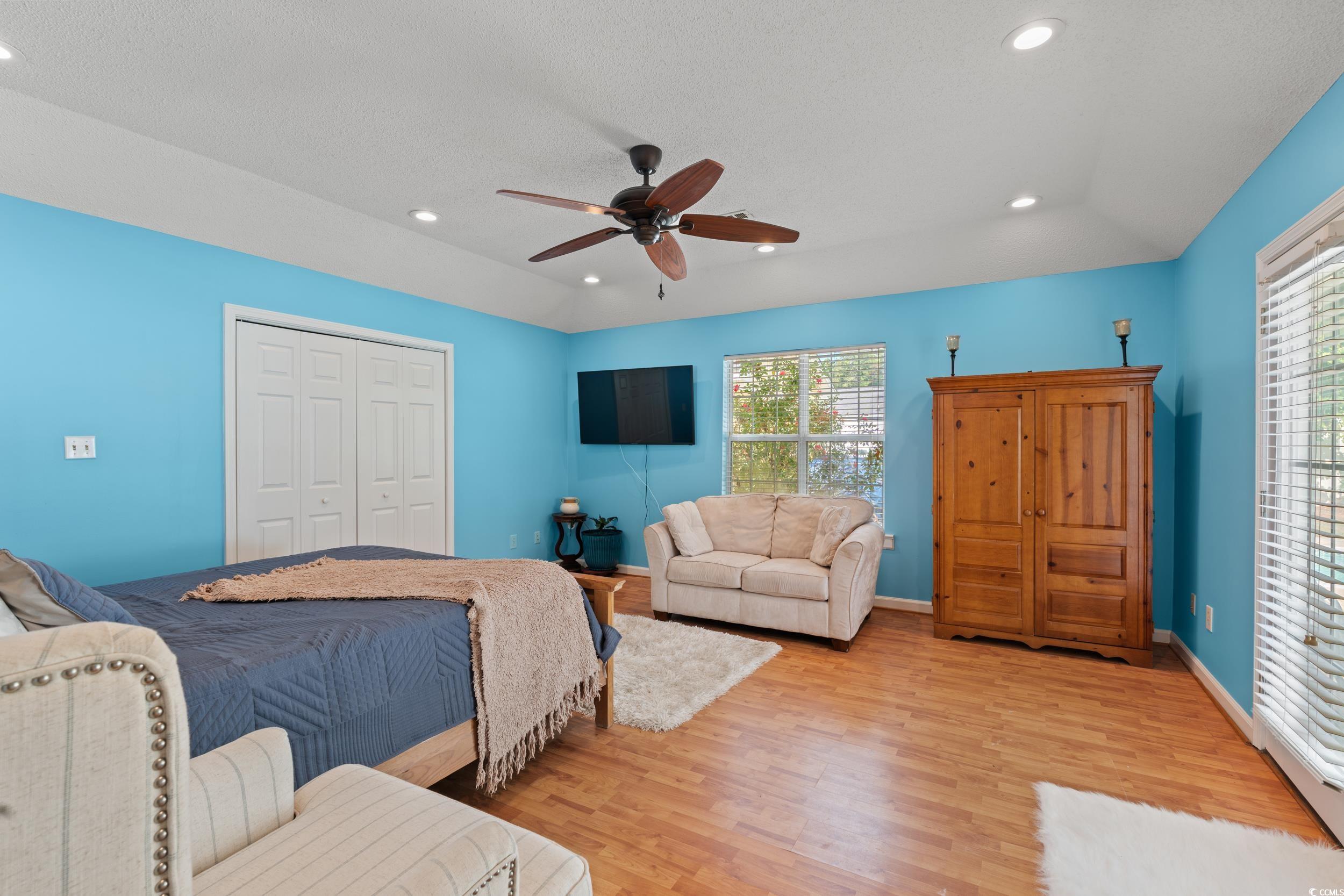 3056 Sweetpine Lane Conway, SC 29527 - Photo 16 of 36 Bedroom with a closet, light wood-type flooring, a ceiling fan, recessed lighting, and a textured ceiling