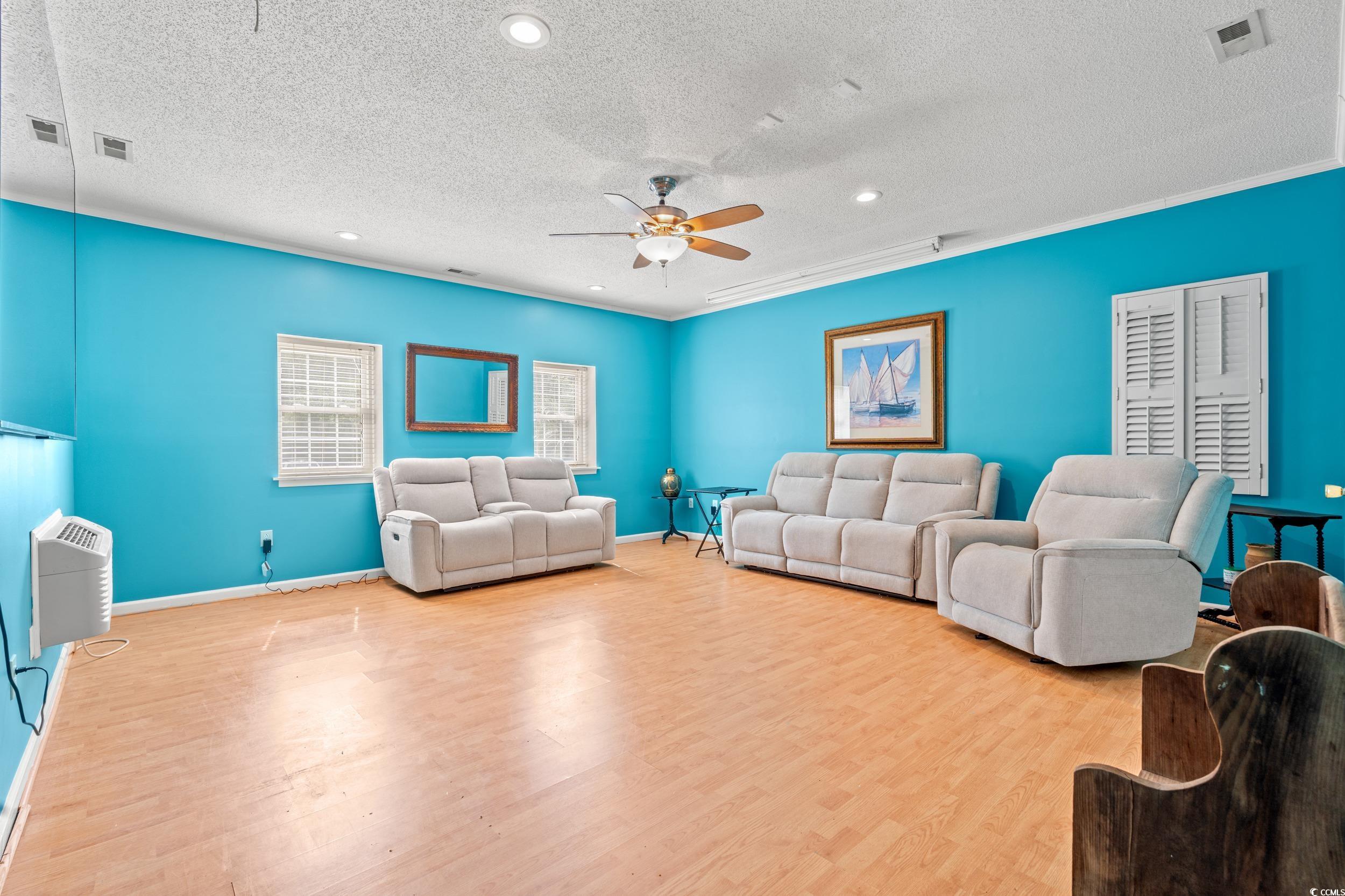 3056 Sweetpine Lane Conway, SC 29527 - Photo 17 of 36 Living room with a textured ceiling, wood finished floors, recessed lighting, a ceiling fan, and ornamental molding