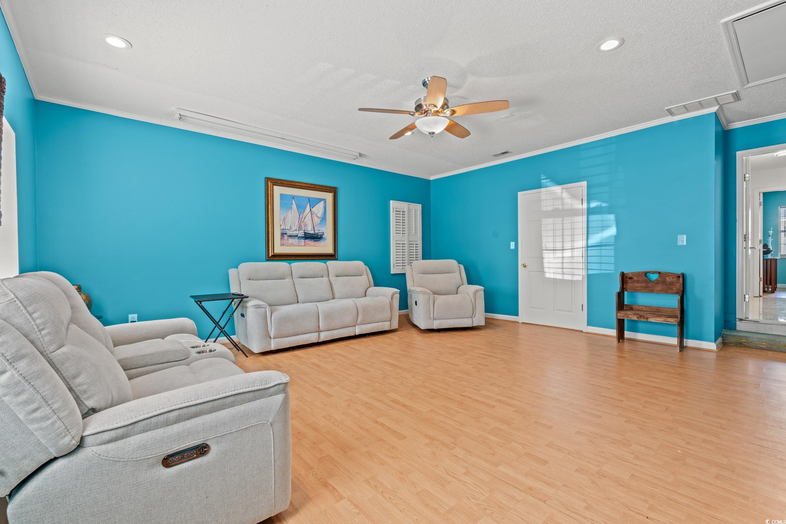 3056 Sweetpine Lane Conway, SC 29527 - Photo 18 of 36 Living area with light wood-type flooring, ornamental molding, a textured ceiling, ceiling fan, and recessed lighting