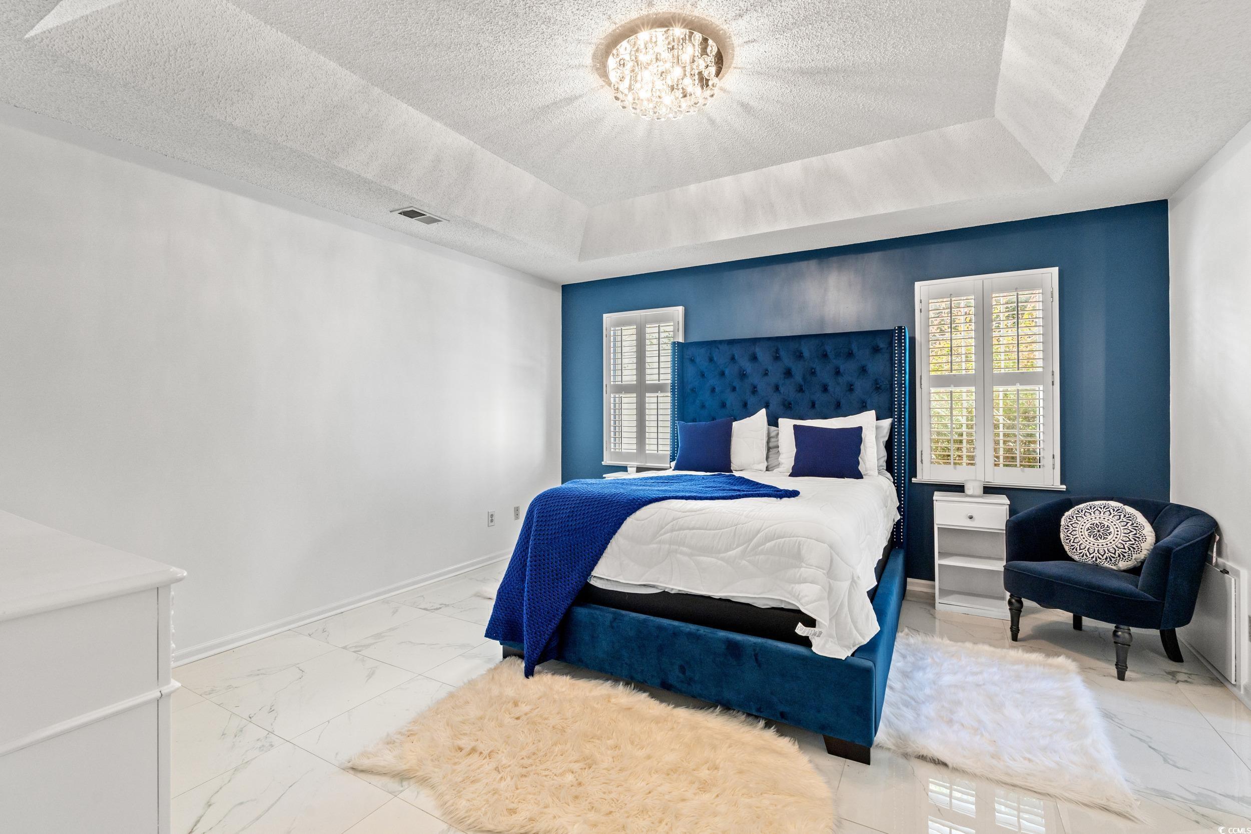 3056 Sweetpine Lane Conway, SC 29527 - Photo 24 of 36 Bedroom with a raised ceiling, a textured ceiling, a chandelier, and multiple windows