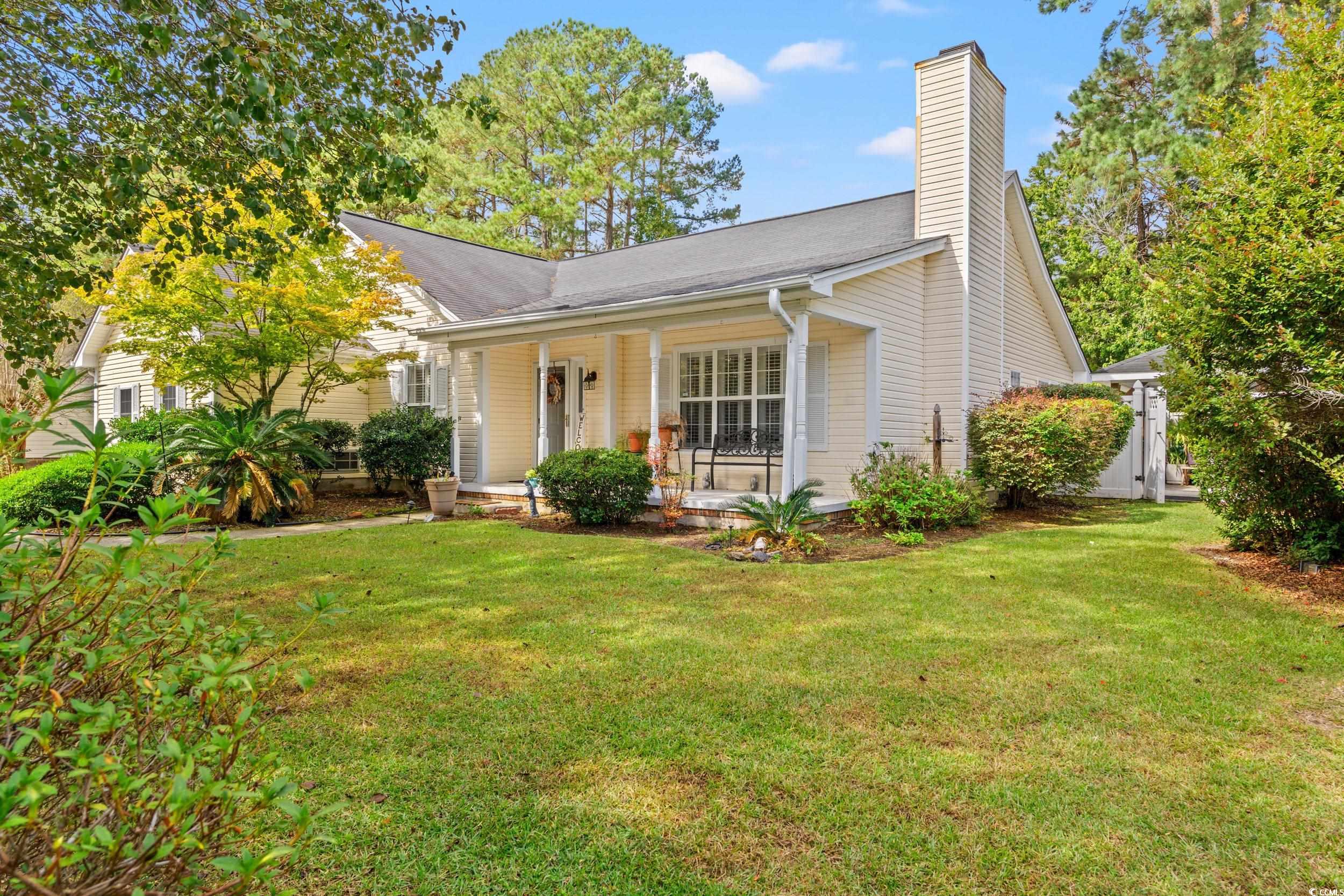 3056 Sweetpine Lane Conway, SC 29527 - Photo 3 of 36 View of front facade featuring a porch, a front yard, and a chimney