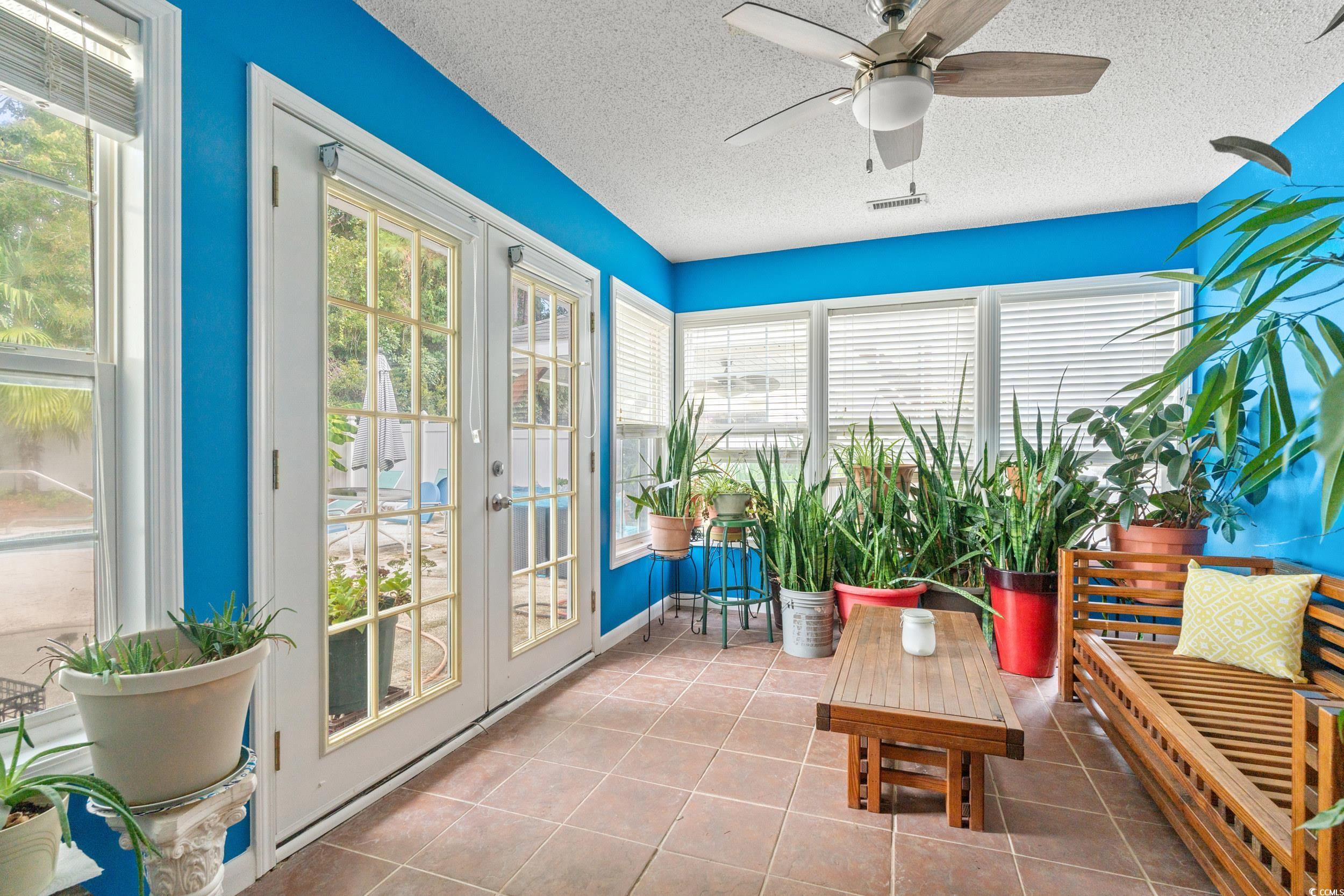 3056 Sweetpine Lane Conway, SC 29527 - Photo 31 of 36 Sunroom / solarium with french doors, healthy amount of natural light, tile patterned floors, and a textured ceiling