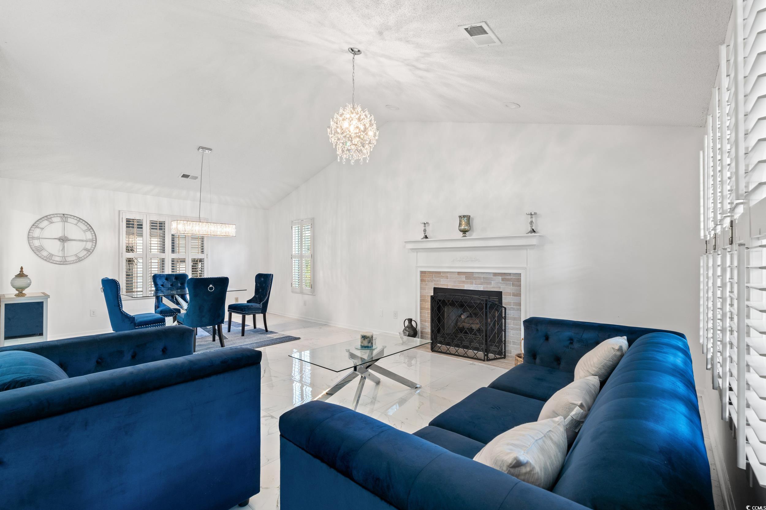 3056 Sweetpine Lane Conway, SC 29527 - Photo 7 of 36 Living area featuring a brick fireplace, a chandelier, marble finish floors, and high vaulted ceiling
