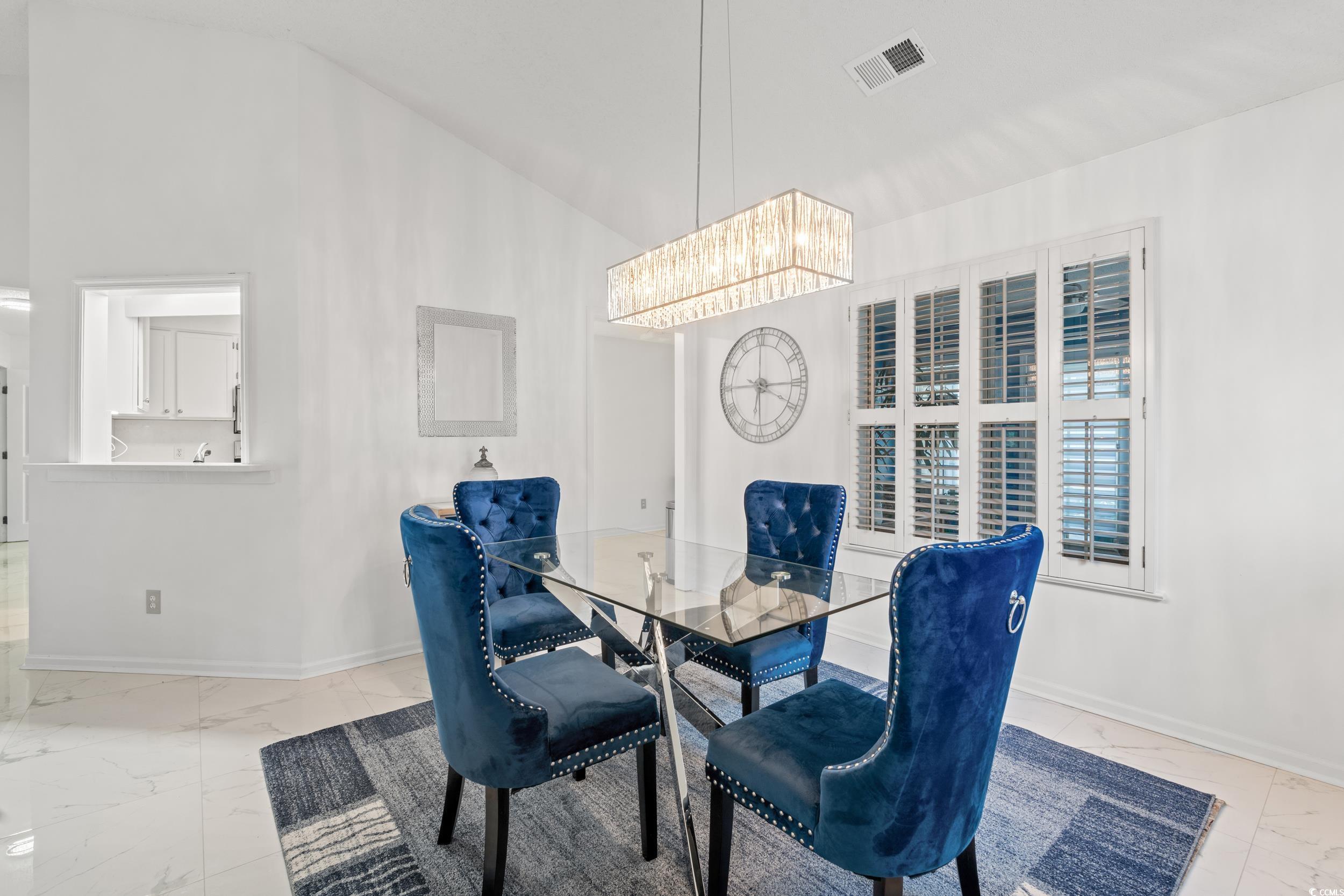3056 Sweetpine Lane Conway, SC 29527 - Photo 10 of 36 Dining room with light marble finish floors, high vaulted ceiling, and a chandelier
