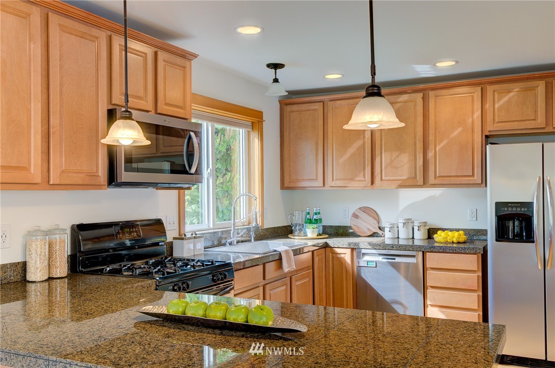 6734 Mars Avenue South Seattle, WA 98108 - Photo 11 of 40 a kitchen with a stove a sink and a microwave