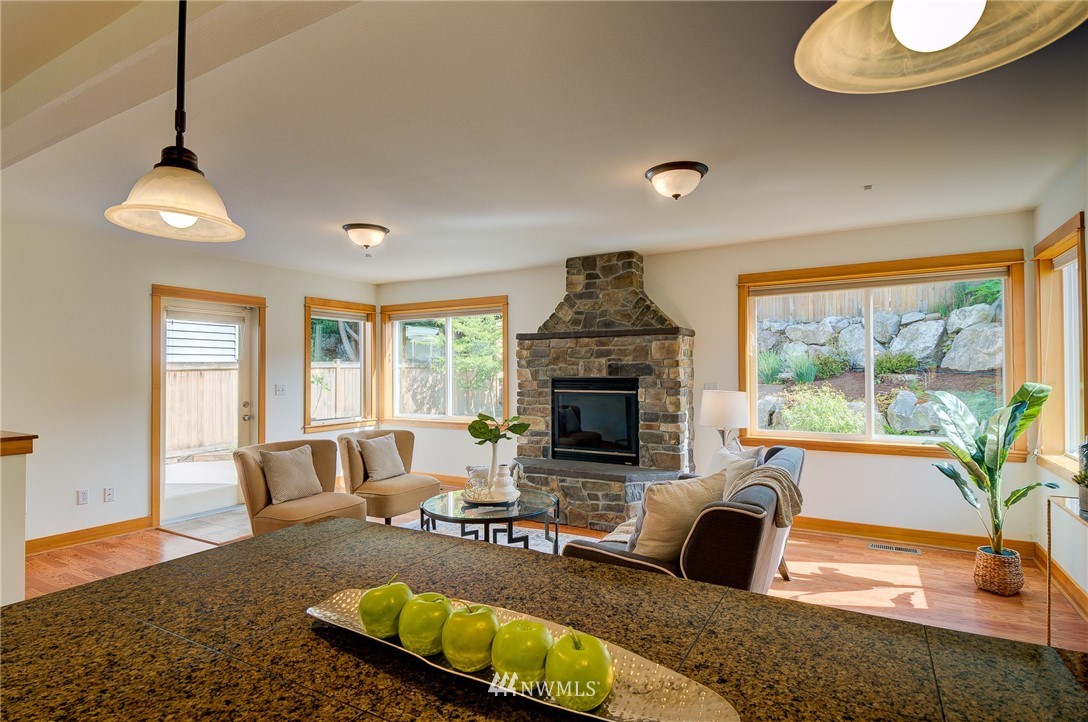 6734 Mars Avenue South Seattle, WA 98108 - Photo 22 of 40 a living room with furniture fireplace and a large window