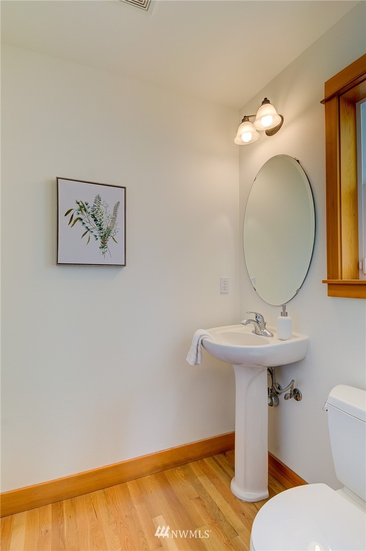 6734 Mars Avenue South Seattle, WA 98108 - Photo 24 of 40 a bathroom with a toilet sink and mirror
