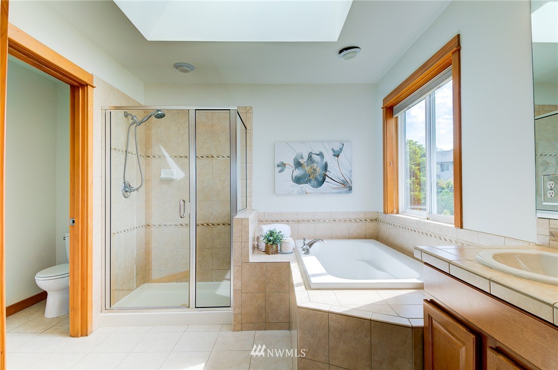 6734 Mars Avenue South Seattle, WA 98108 - Photo 30 of 40 a bathroom with a granite countertop sink a toilet and shower