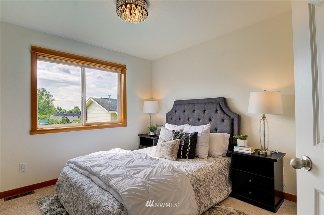 6734 Mars Avenue South Seattle, WA 98108 - Photo 32 of 40 a bedroom with a bed and a window