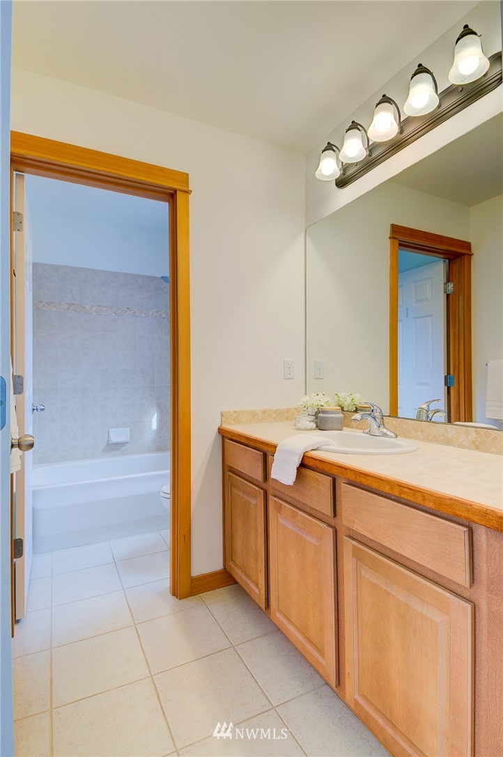 6734 Mars Avenue South Seattle, WA 98108 - Photo 35 of 40 a bathroom with a sink and a mirror