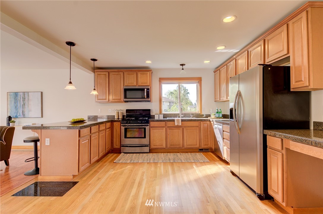 6734 Mars Avenue South Seattle, WA 98108 - Photo 9 of 40 a kitchen with stainless steel appliances a refrigerator sink and microwave