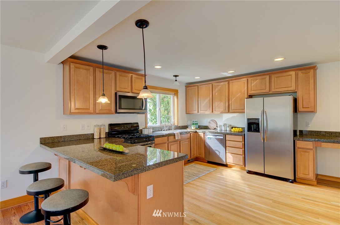 6734 Mars Avenue South Seattle, WA 98108 - Photo 10 of 40 a kitchen with stainless steel appliances granite countertop a sink refrigerator and microwave