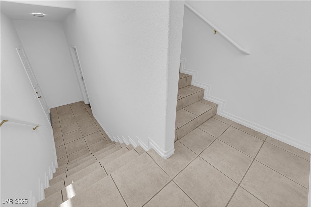 10550 West Alexander Road, Unit 2079 Las Vegas, NV 89129 - Photo 27 of 40 Stairs with tile patterned floors and baseboards