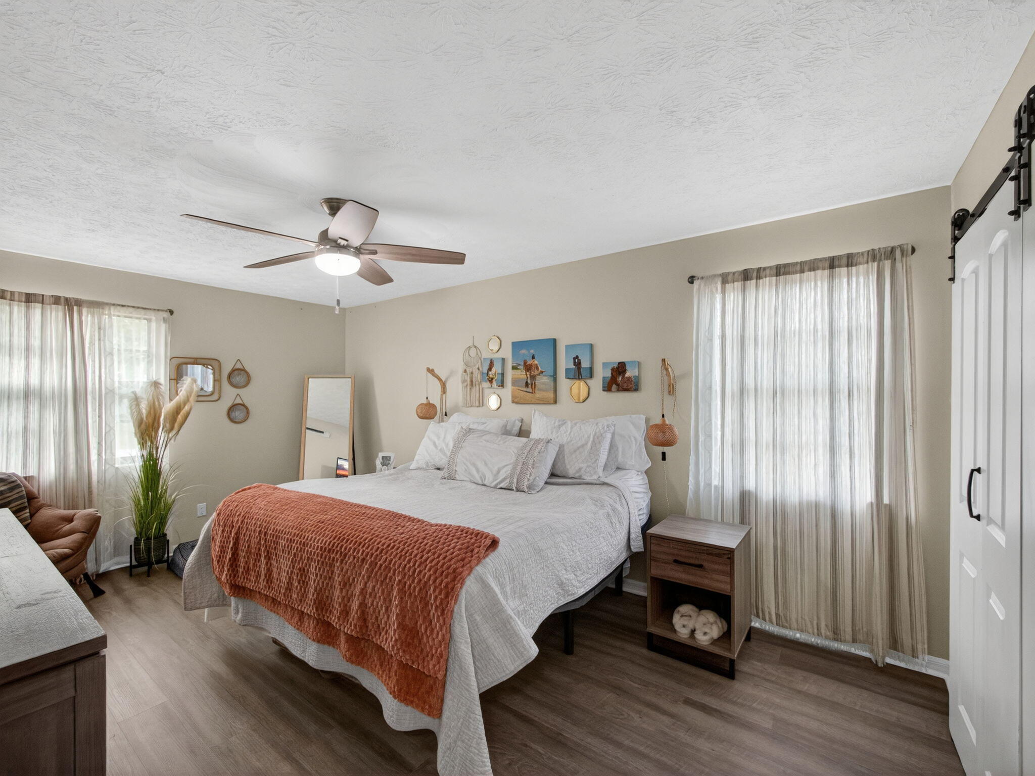 991 Northwest 15th Terrace Stuart, FL 34994 - Photo 11 of 24 a bedroom with a bed and a chandelier