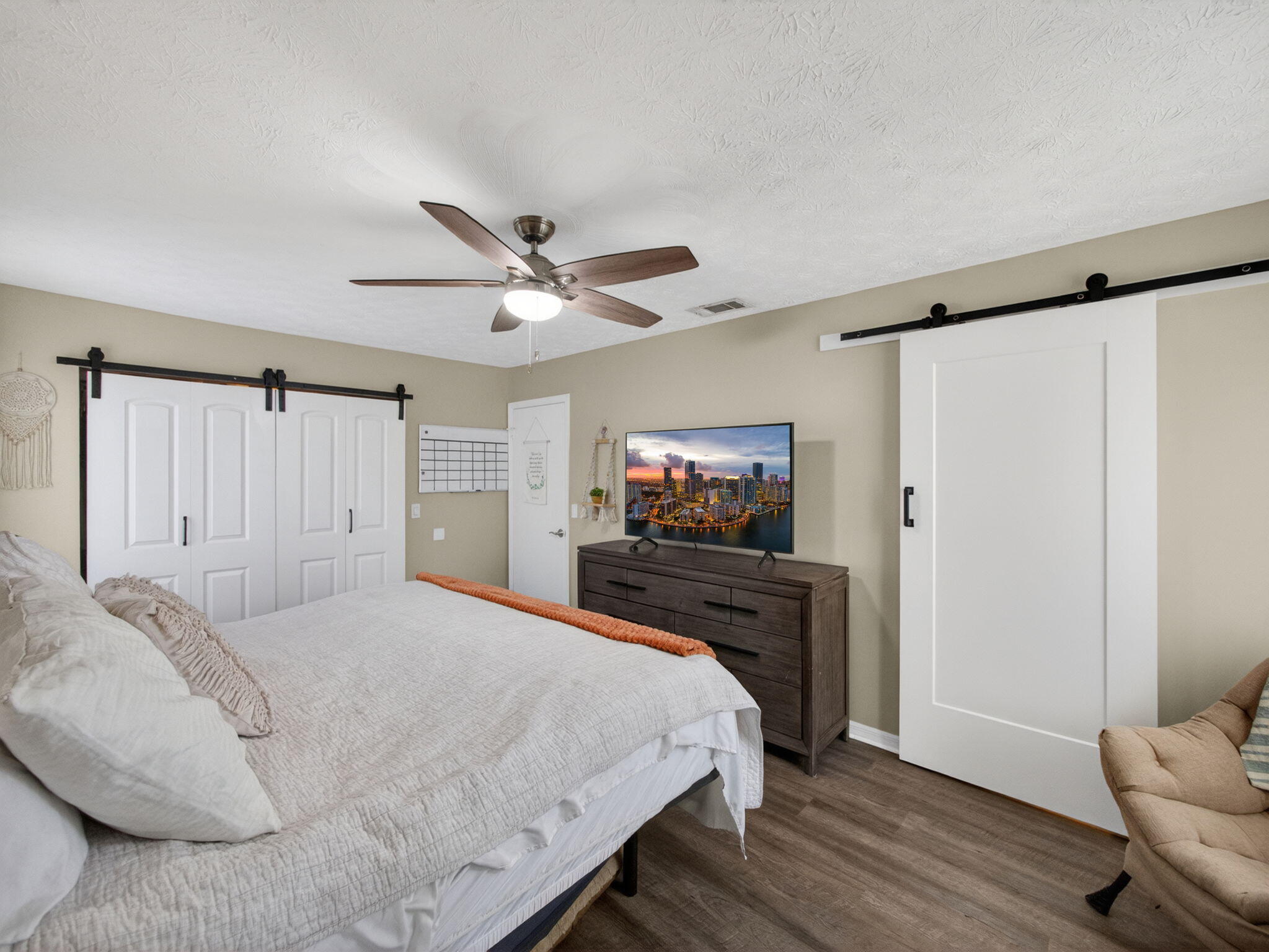 991 Northwest 15th Terrace Stuart, FL 34994 - Photo 13 of 24 a bedroom with a bed and a flat screen tv