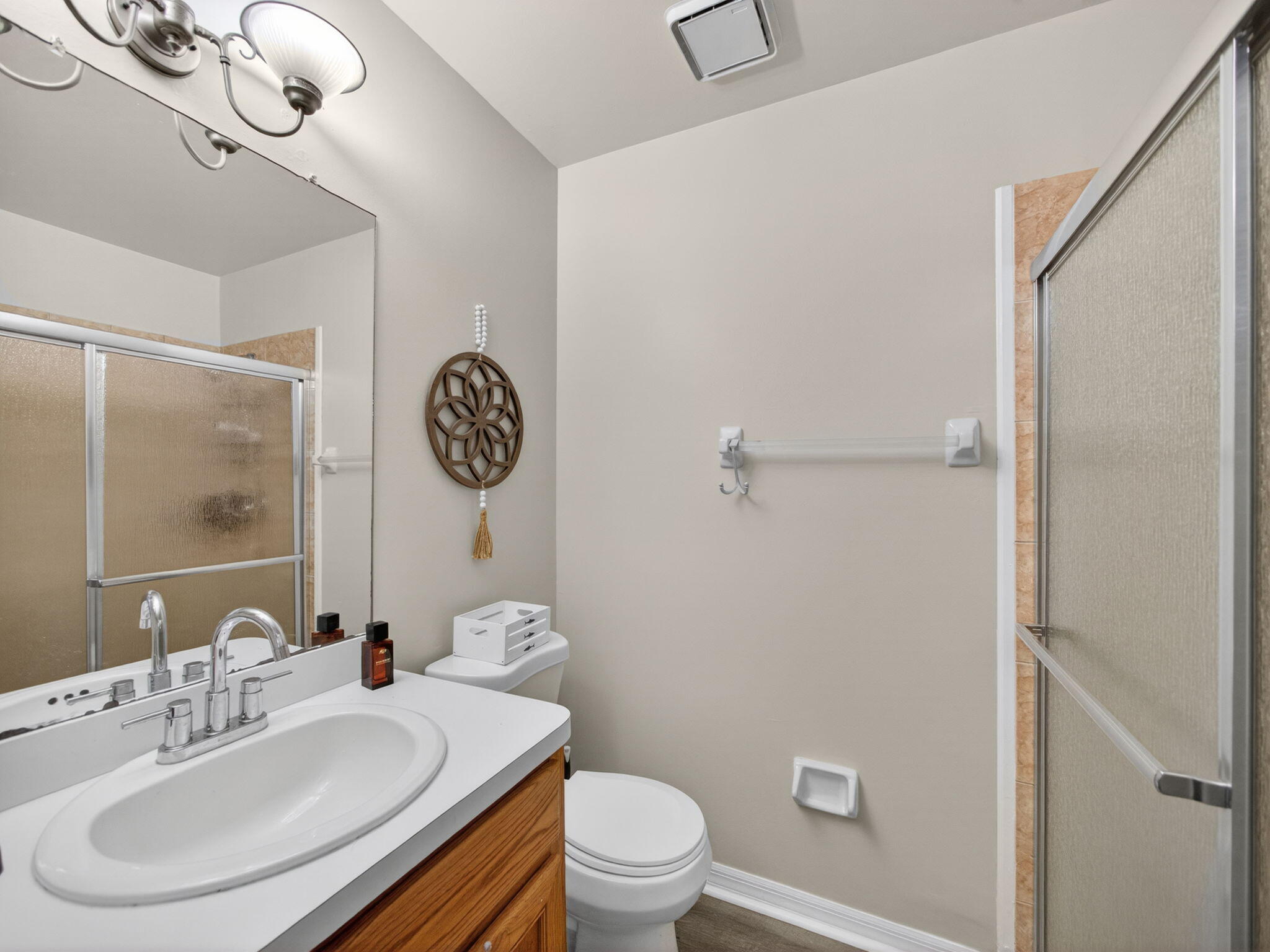 991 Northwest 15th Terrace Stuart, FL 34994 - Photo 14 of 24 a bathroom with a toilet a sink and a mirror