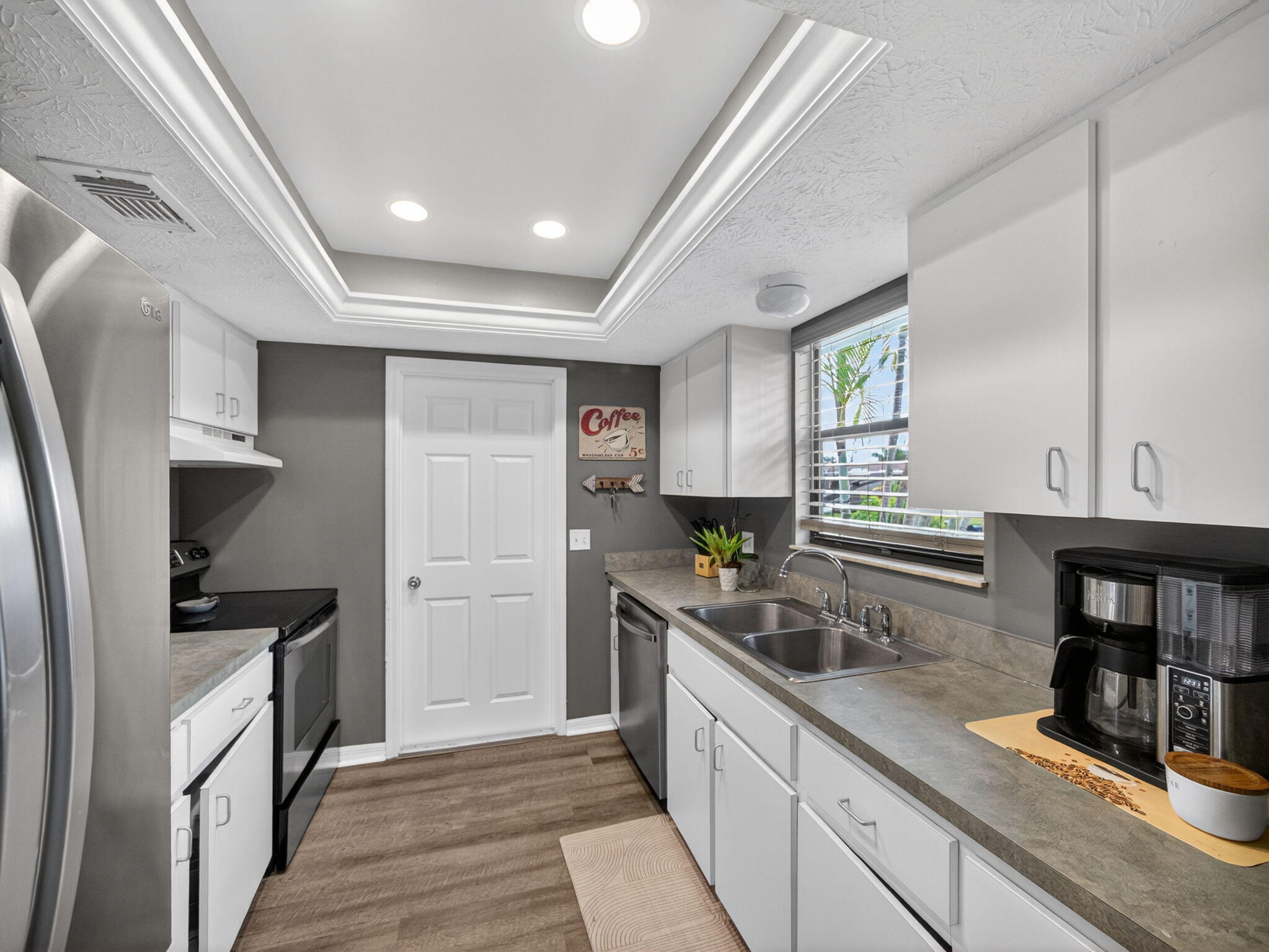 991 Northwest 15th Terrace Stuart, FL 34994 - Photo 5 of 24 a kitchen with granite countertop a sink a counter space appliances and cabinets