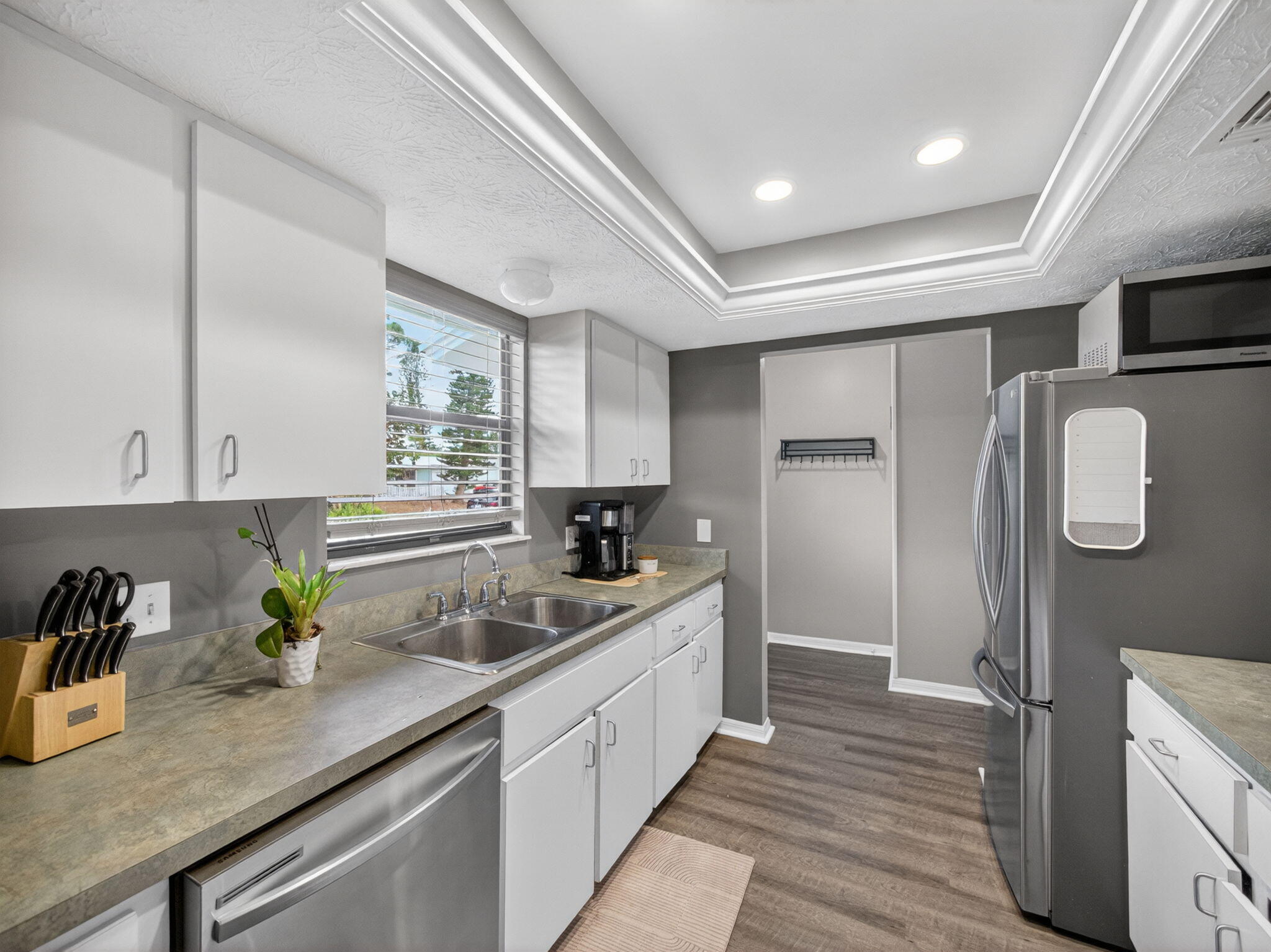 991 Northwest 15th Terrace Stuart, FL 34994 - Photo 6 of 24 a kitchen with a sink a counter space cabinets and appliances