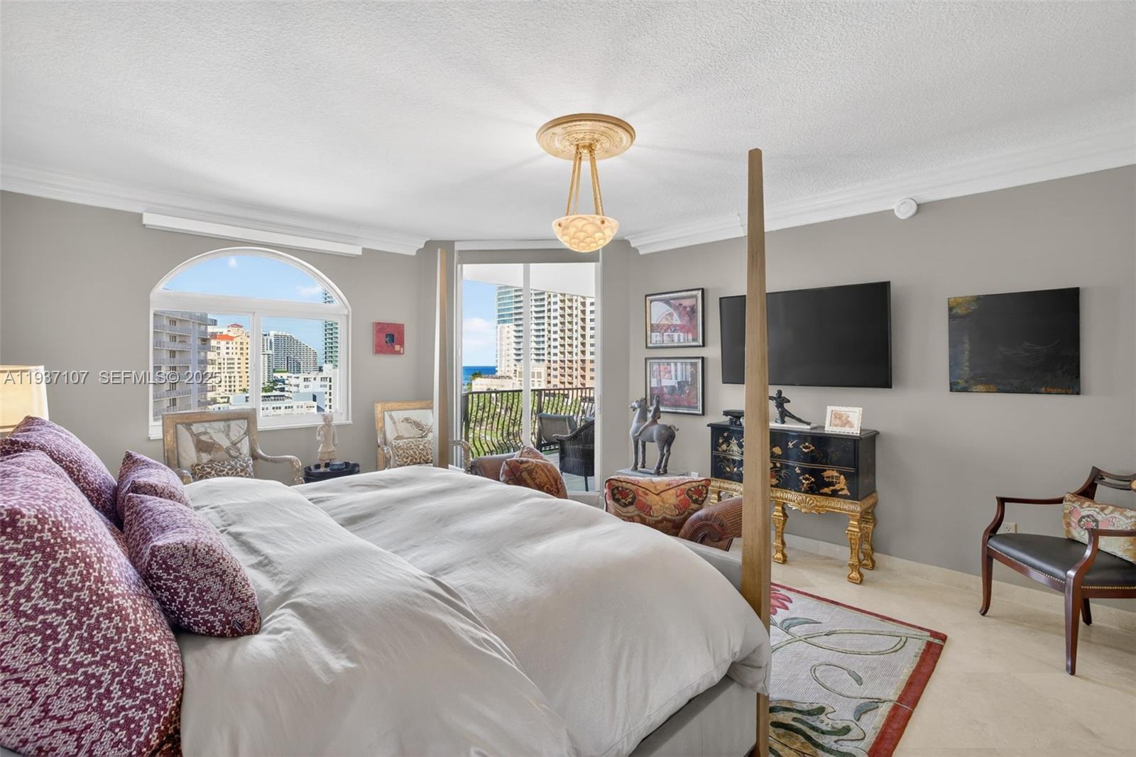 100 South Birch Road, Unit 1103F Fort Lauderdale, FL 33316 - Photo 5 of 80 Primary bedroom w/ beautiful views of intracoastal and to balcony and ocean. Motorized window treatments. Chandelier does not convey.