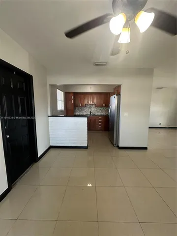 a view of kitchen and a refrigerator in a kitchen