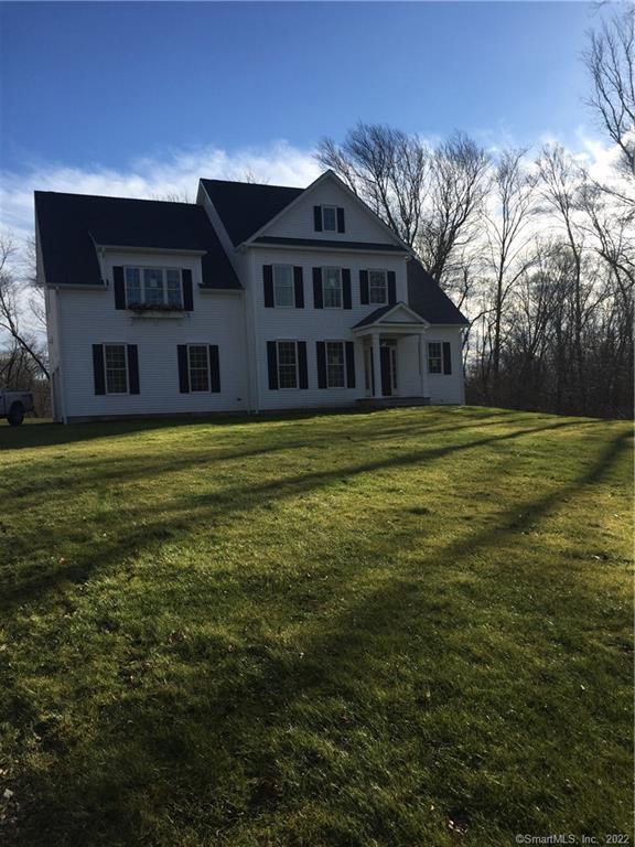 63 Robin Hill Road, Unit 14 Newtown, CT 06470 - Photo 1 of 1 a big white house next to a big yard and large trees