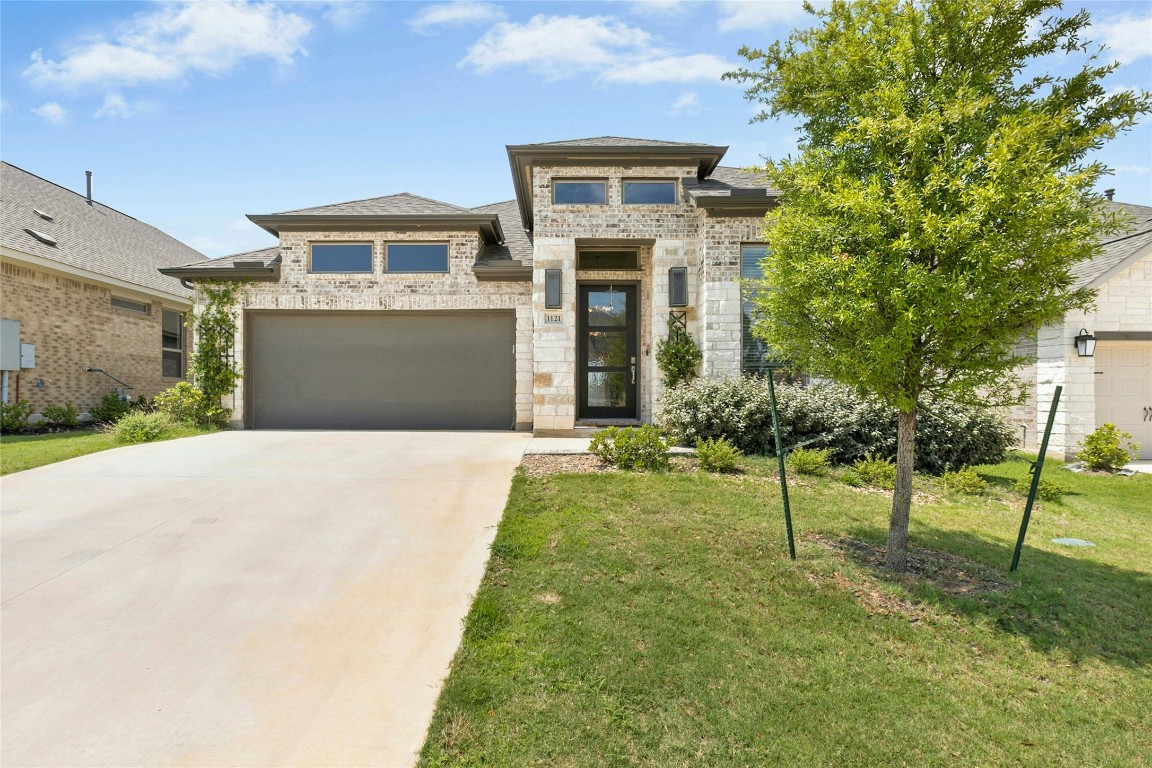 1121 Spring Gulch Lane Georgetown, TX 78628 - Photo 1 of 33 a front view of a house with a yard
