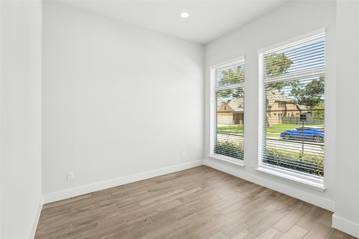1121 Spring Gulch Lane Georgetown, TX 78628 - Photo 18 of 33 an empty room with wooden floor and windows