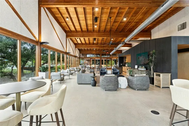 a view of a patio with table and chairs and wooden floor
