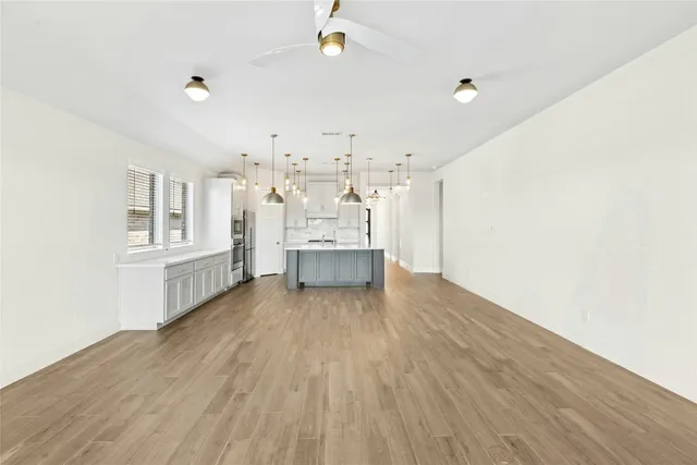 a view of a living room hardwood and kitchen with wooden floor