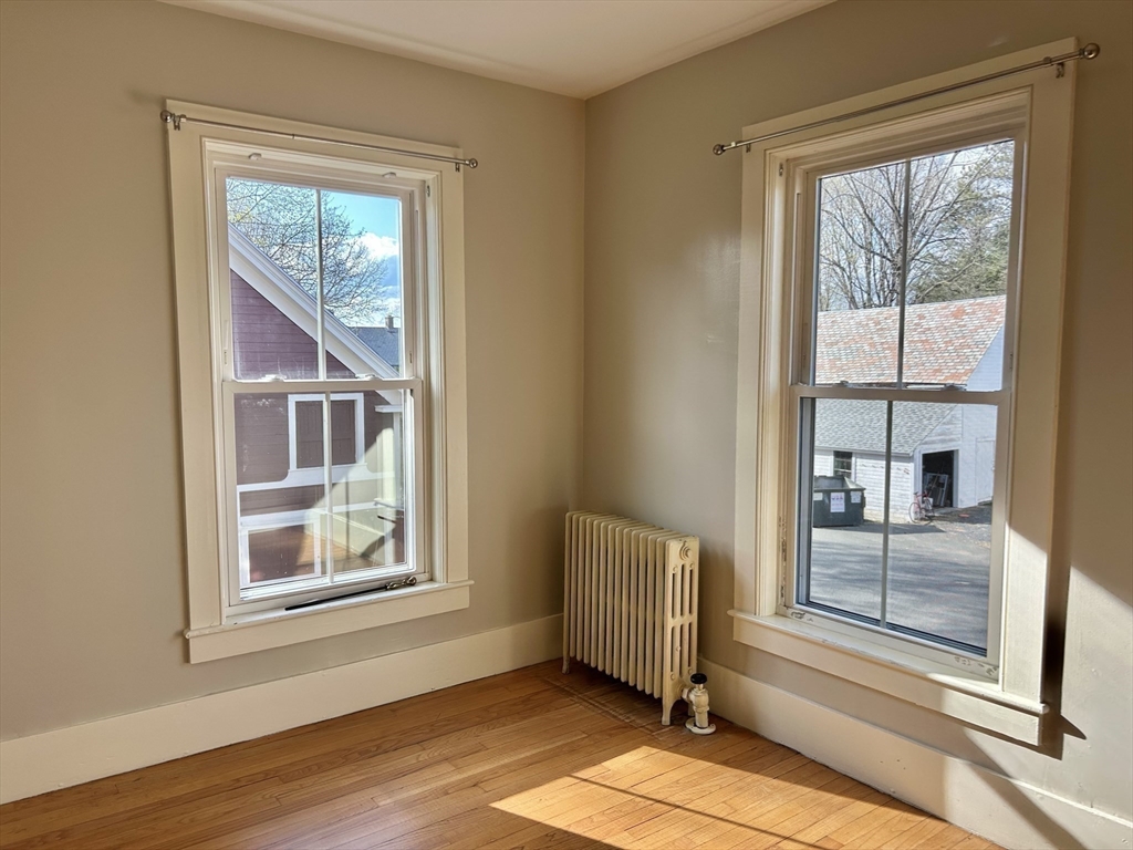 48 Congress Street Greenfield, MA 01301 - Photo 13 of 36 a view of an empty room and wooden floor and a window