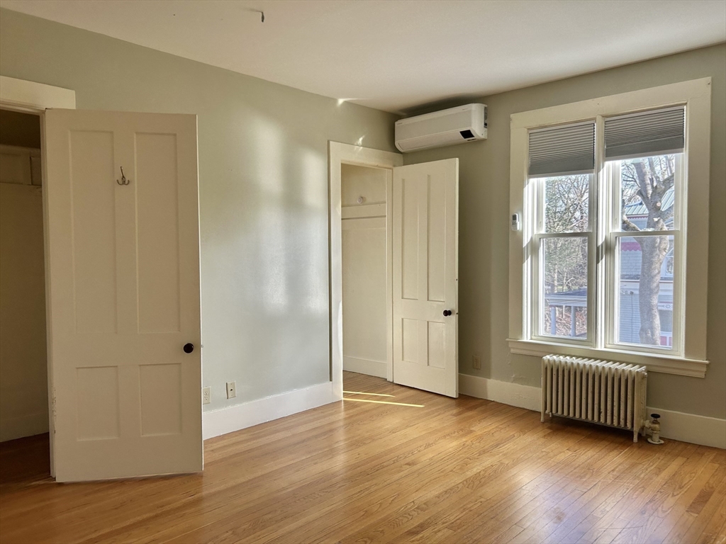 48 Congress Street Greenfield, MA 01301 - Photo 17 of 36 a view of an empty room with wooden floor and a window