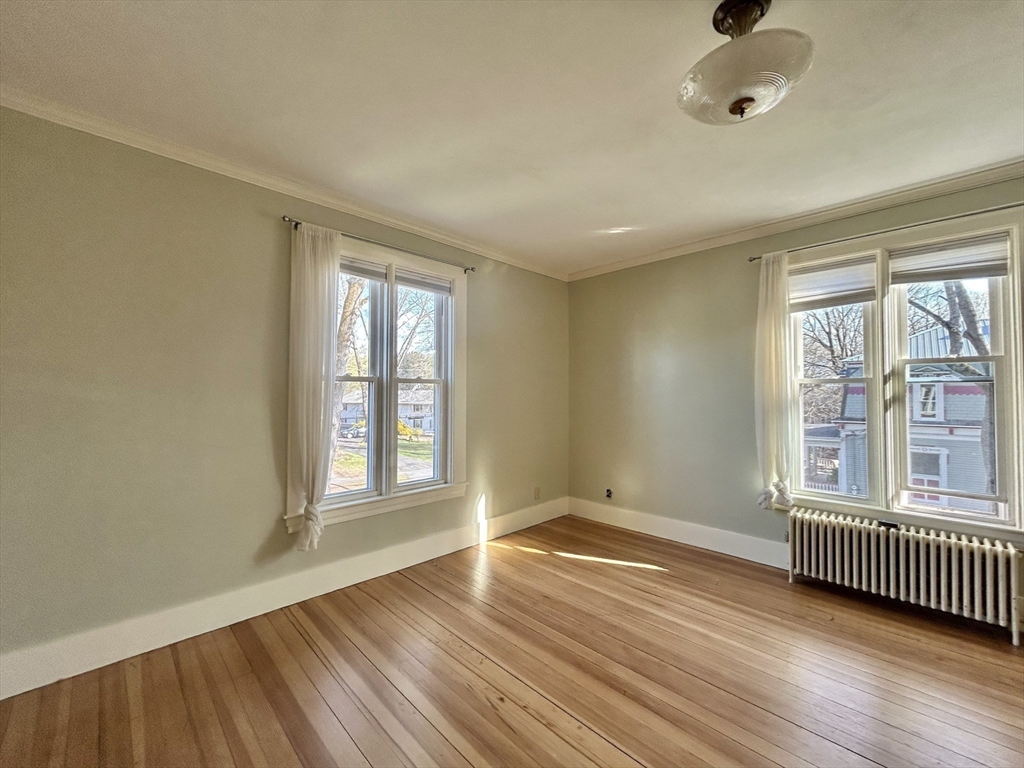 48 Congress Street Greenfield, MA 01301 - Photo 18 of 36 an empty room with wooden floor and windows