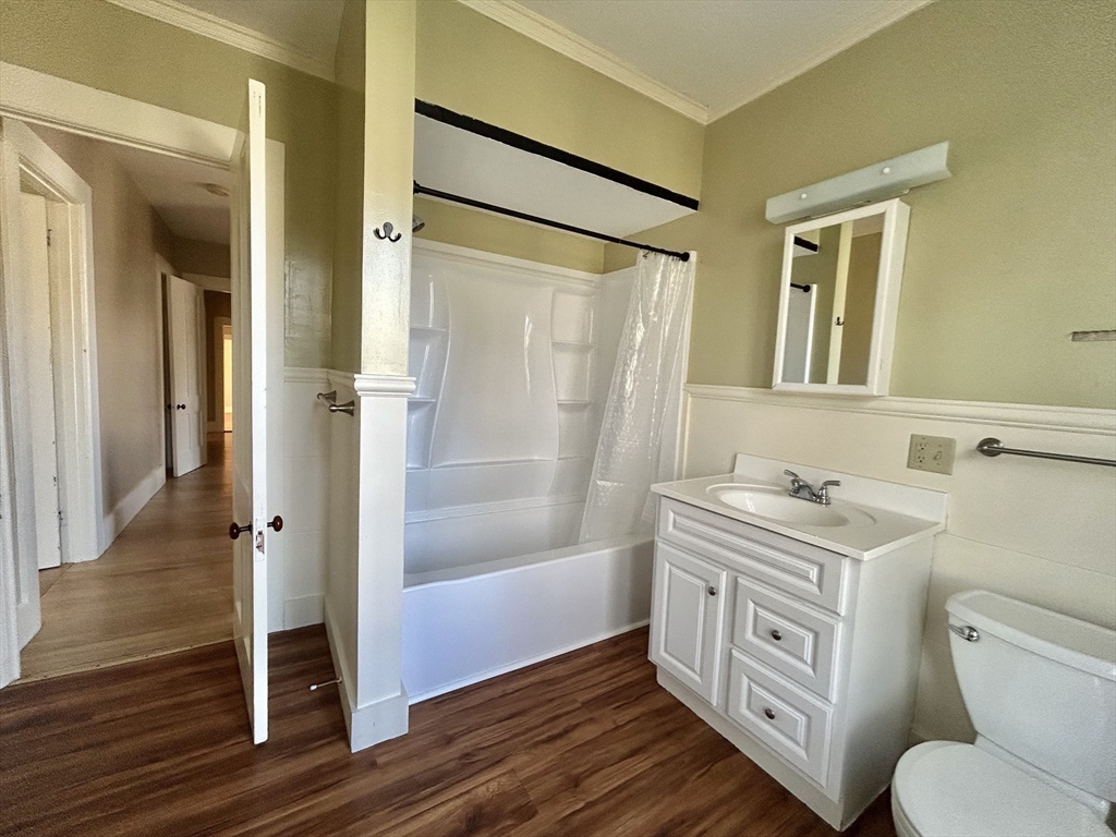 48 Congress Street Greenfield, MA 01301 - Photo 19 of 36 a bathroom with a granite countertop toilet a sink and a mirror