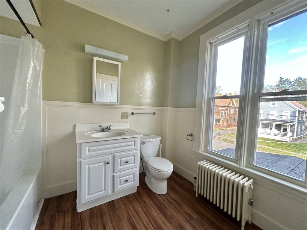 48 Congress Street Greenfield, MA 01301 - Photo 20 of 36 a bathroom with a toilet sink and a large mirror