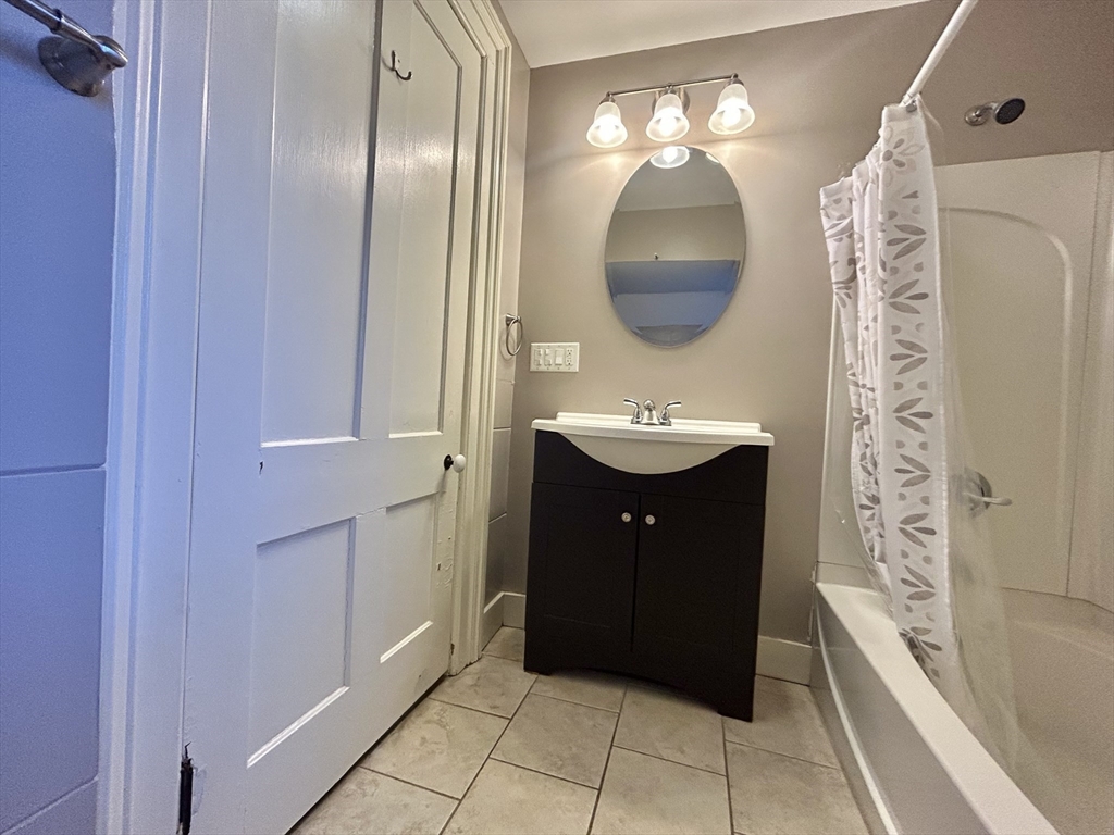 48 Congress Street Greenfield, MA 01301 - Photo 22 of 36 a bathroom with a double vanity sink and a mirror