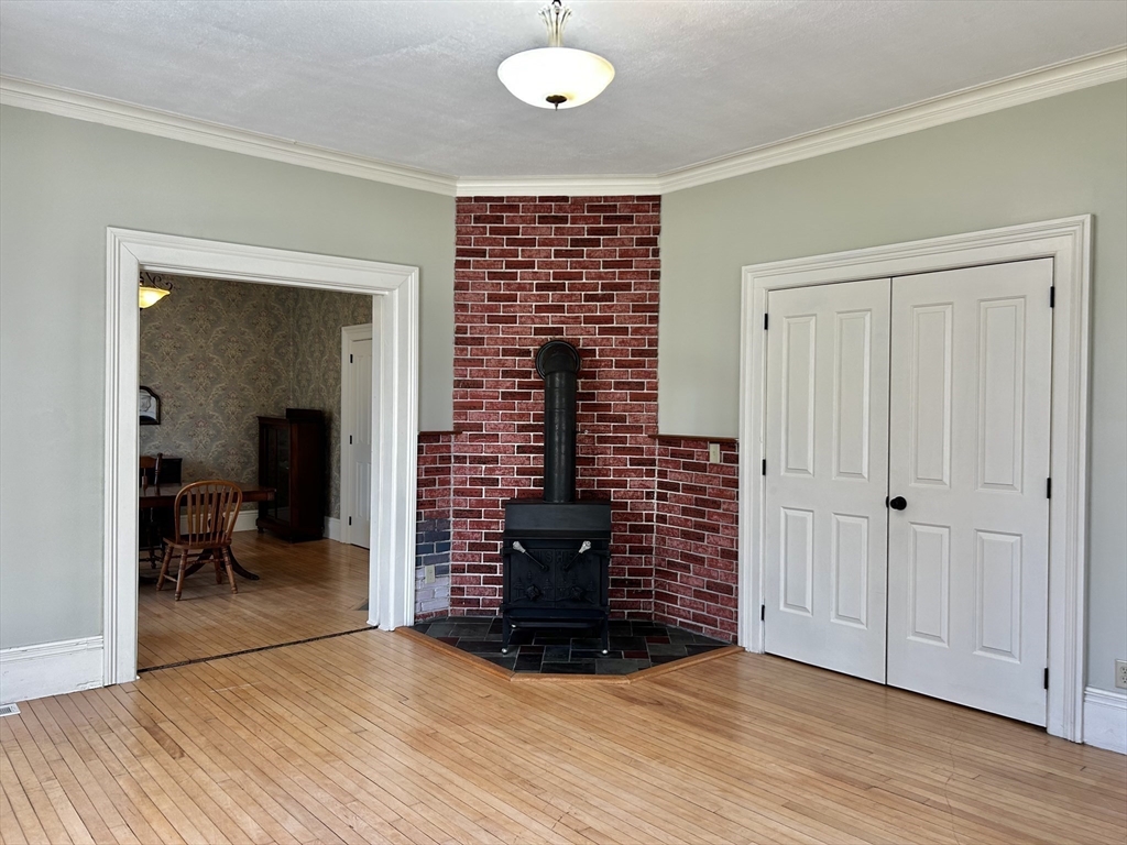 48 Congress Street Greenfield, MA 01301 - Photo 5 of 36 a view of an empty room with wooden floor and a window