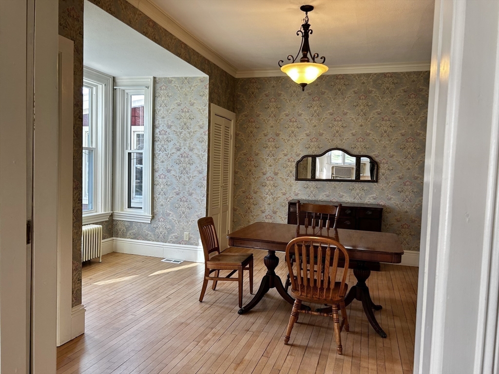 48 Congress Street Greenfield, MA 01301 - Photo 8 of 36 a view of a dining room with furniture and wooden floor