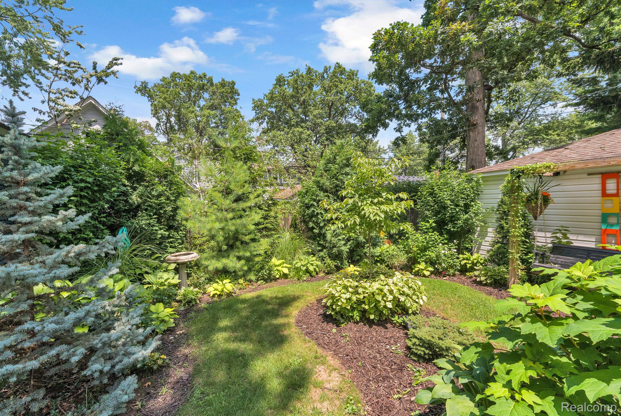 21 Devonshire Road Pleasant Ridge, MI 48069 - Photo 6 of 35 Expansive landscaped backyard with mature trees and diverse plantings