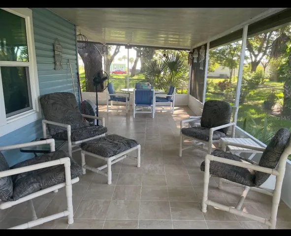 a building outdoor space with patio furniture and potted plants