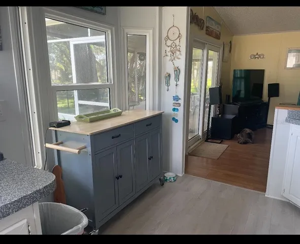 a bathroom with a granite countertop sink a mirror and a shower