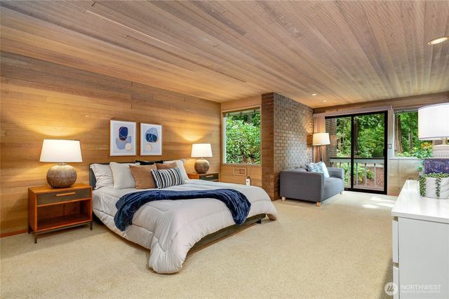 a bed room with a bed and large window