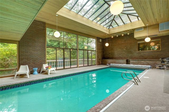 a room with pool table and windows